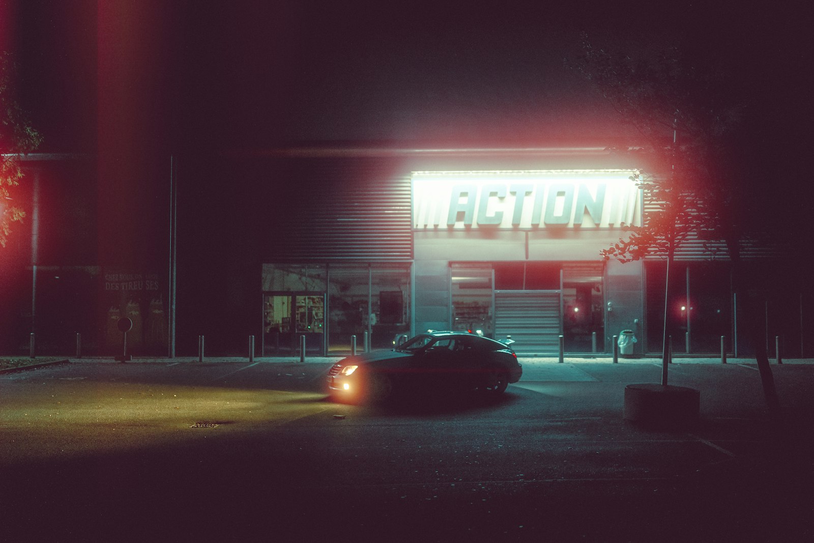 A car parked in front of a building at night